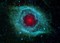 Dust makes this cosmic eye look red.